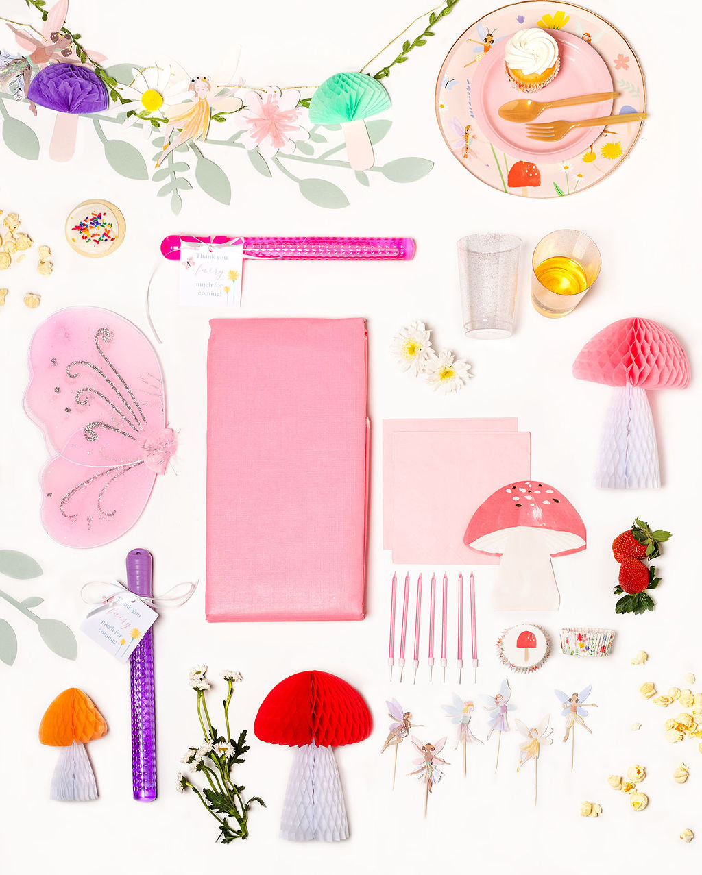 Fairy-themed birthday party pack with floral and fairy plates, mushroom napkins, and enchanted forest decorations