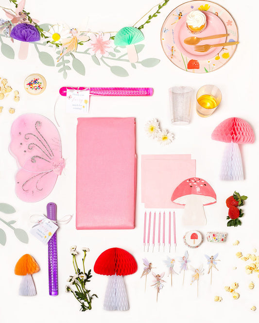 Fairy-themed birthday party pack with floral and fairy plates, mushroom napkins, and enchanted forest decorations