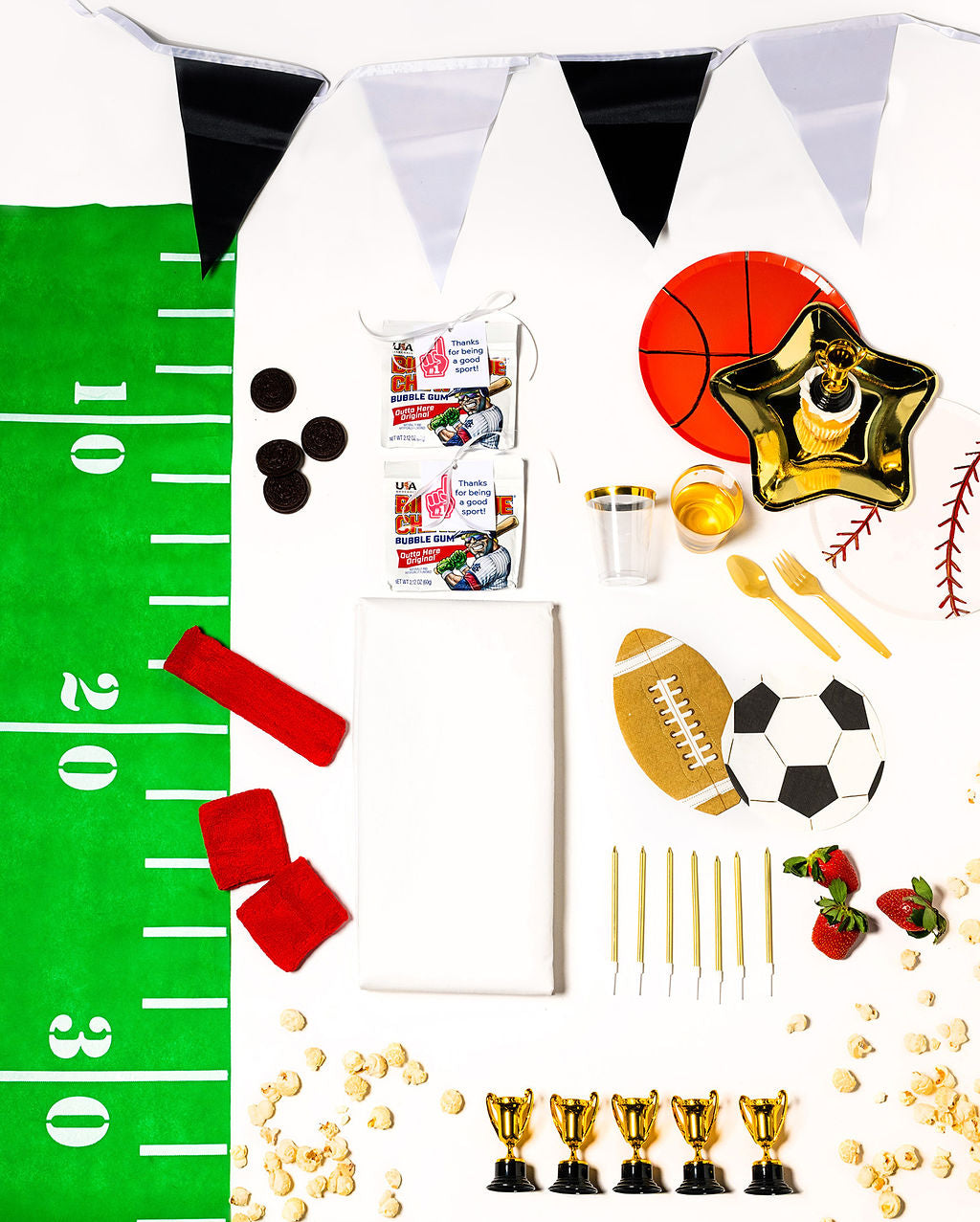 Sports-themed birthday party pack with soccer, football, basketball, and baseball plates and decor