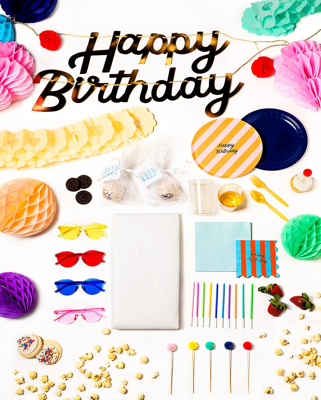 Colorful Happy Everything party pack with rainbow plates, napkins, and festive decor