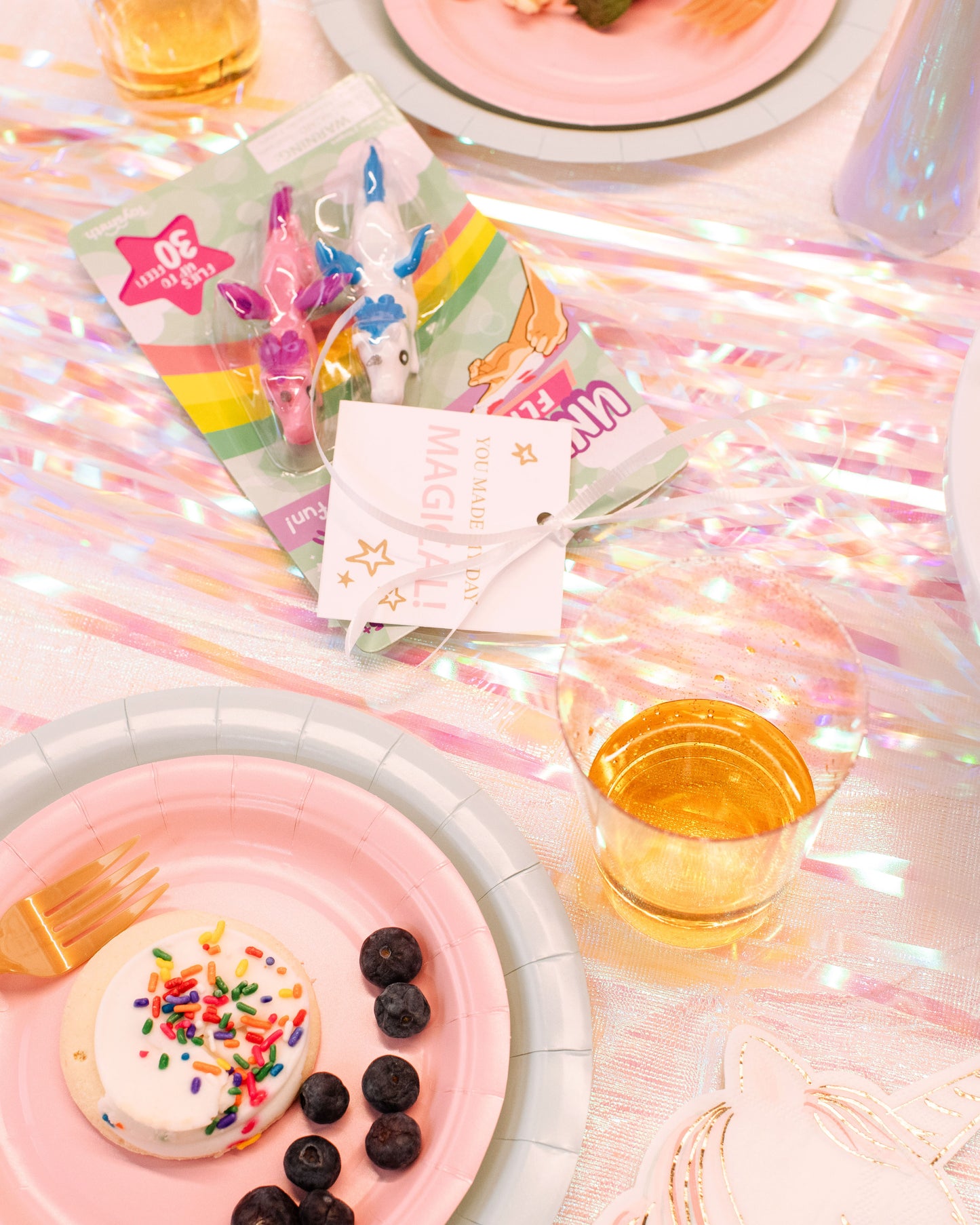 Unicorn party favors including glitter horn party hats, and unicorn party favors