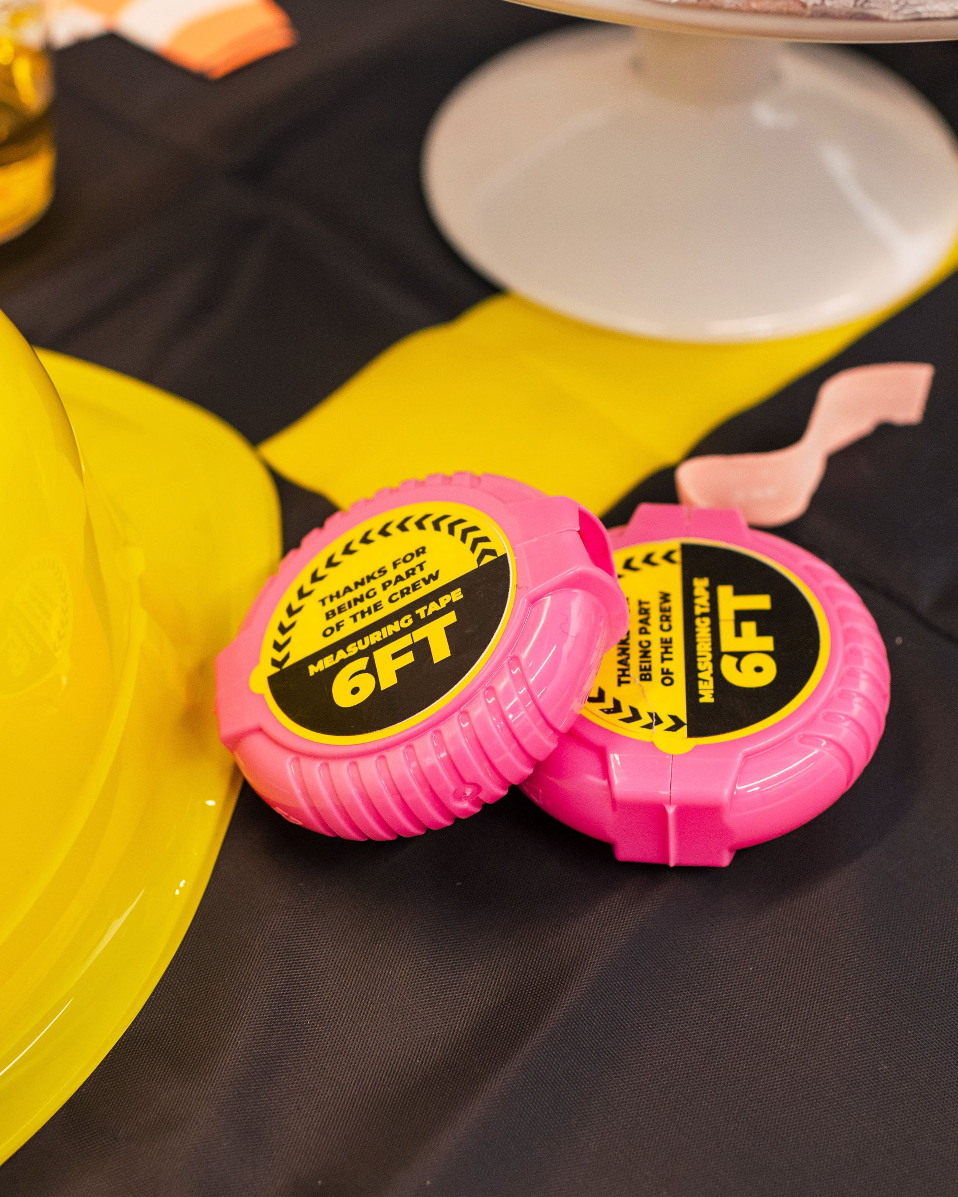 Construction party favors including construction hats and measuring tape gum