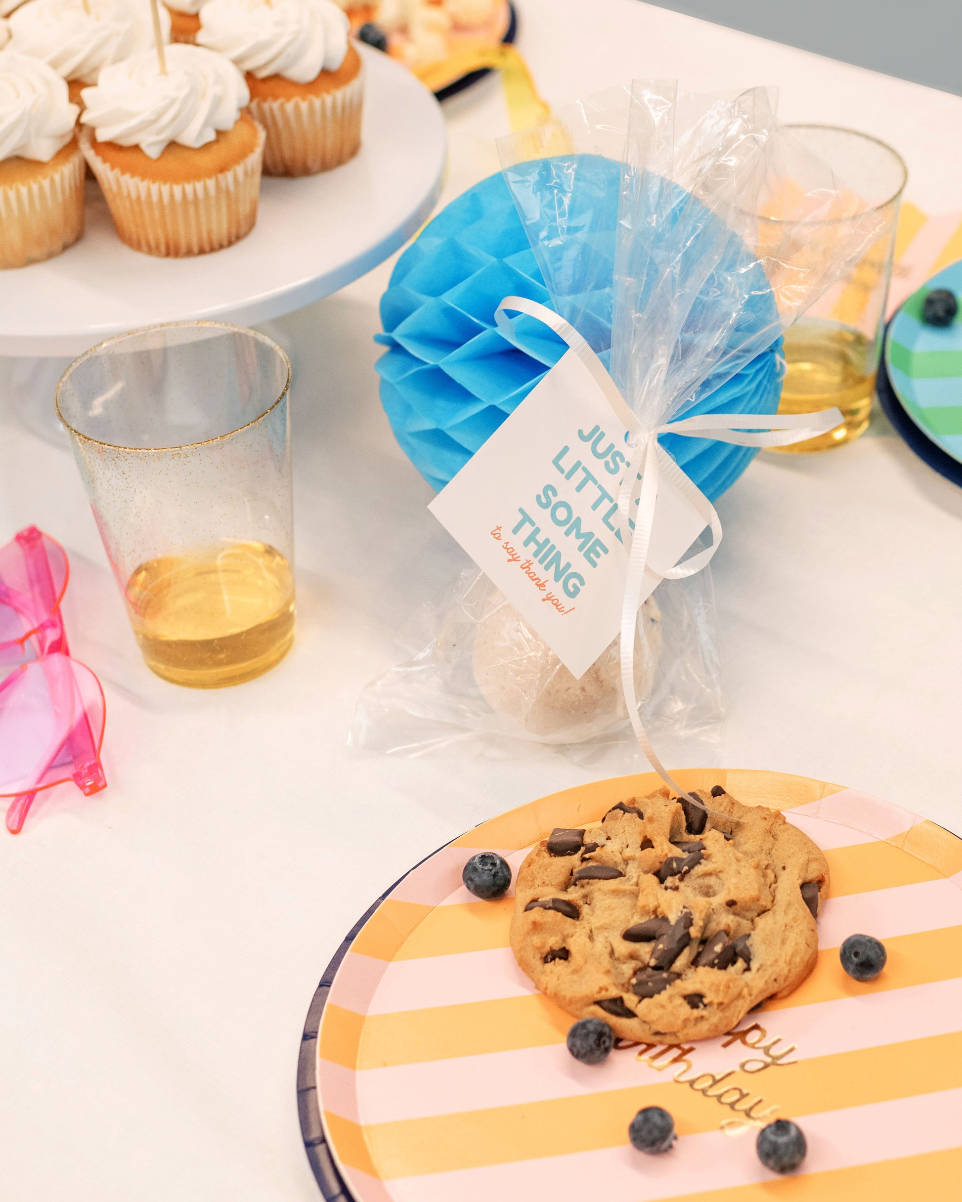 Rainbow party glasses and colorful favor bags from the Happy Everything party kit