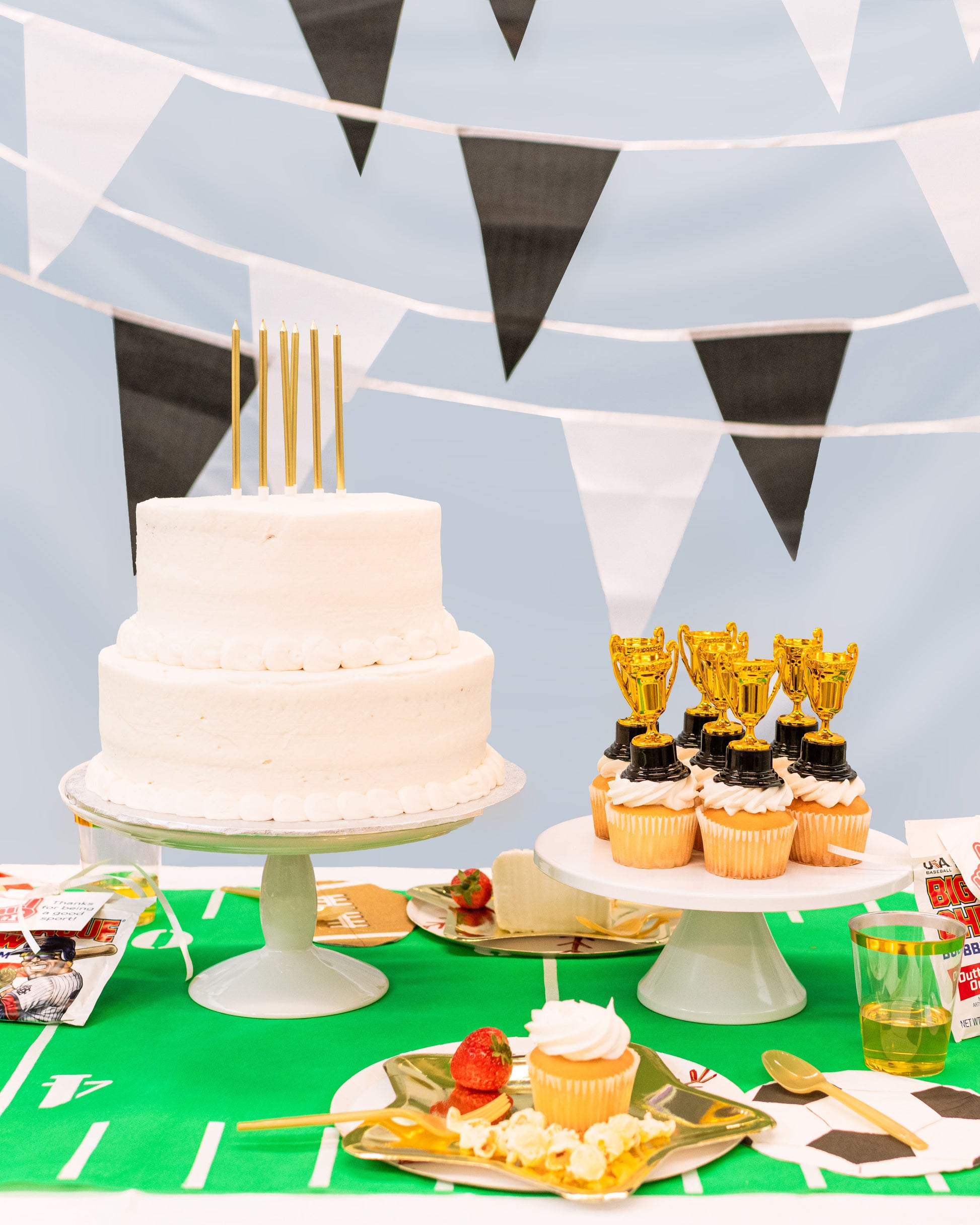Kids sports birthday party table decorated with themed tableware, referee style garland, and game-day accents