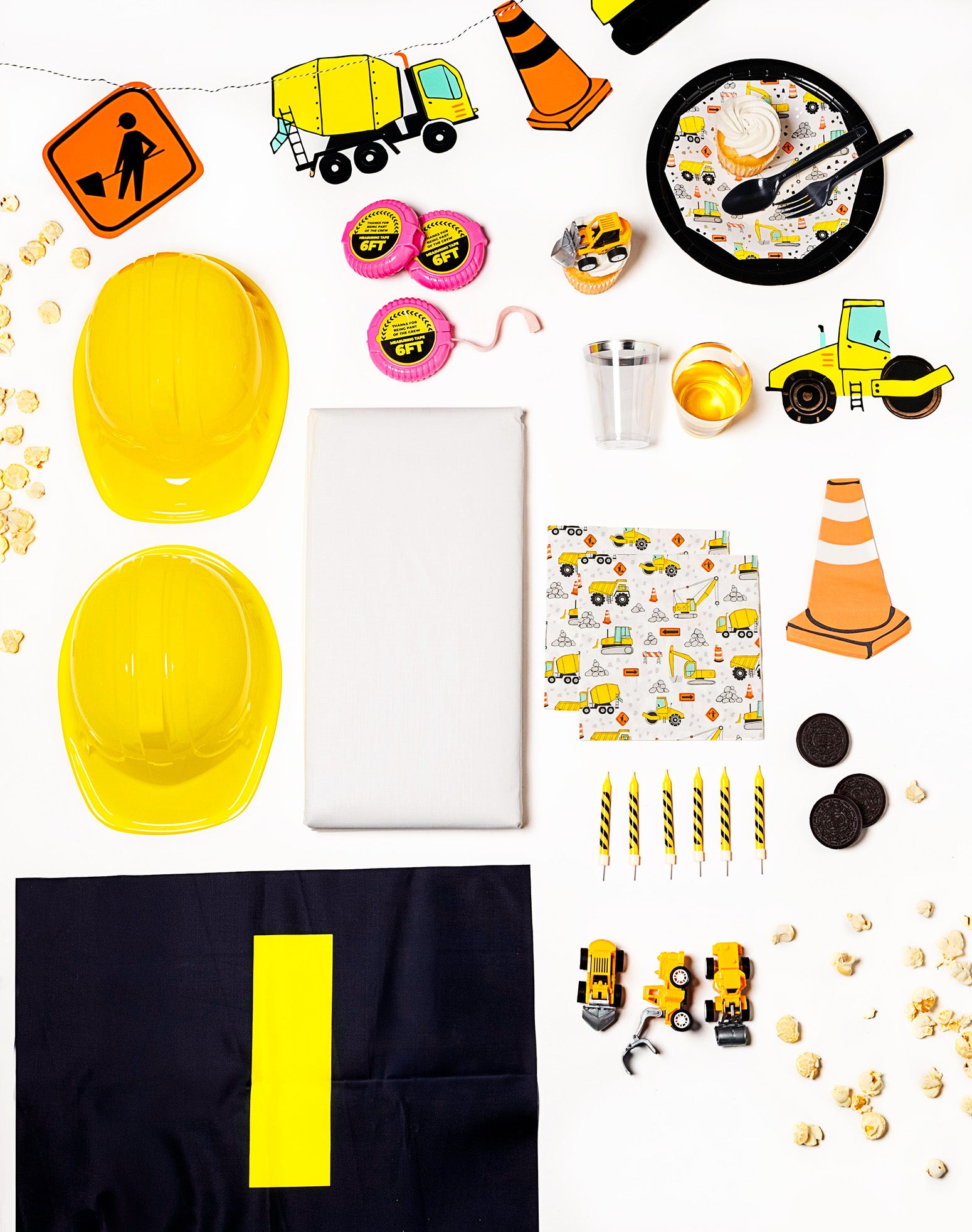 Construction party pack with construction machine plates, napkins shaped like cones, and tool-themed decor